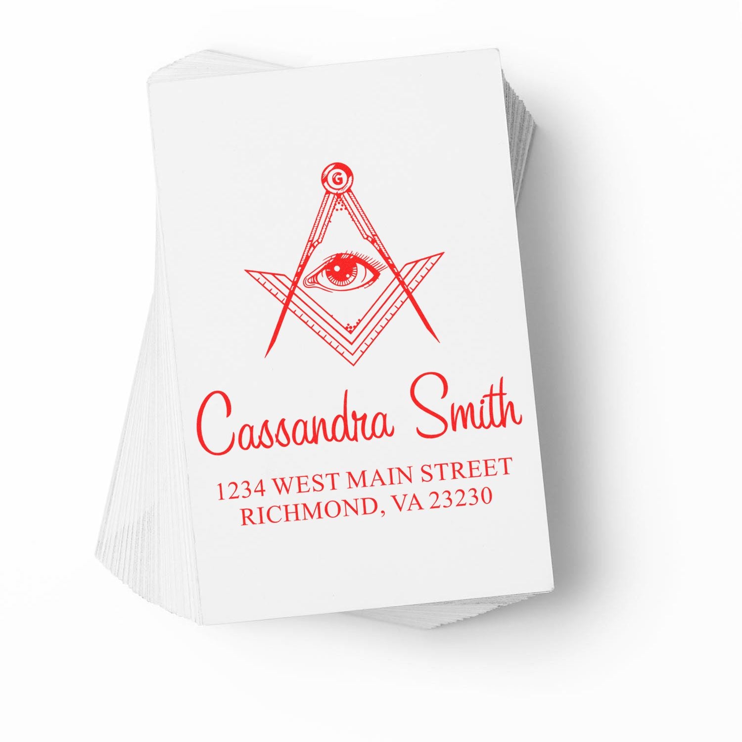 Custom rubber stamp design with eye-and-compass logo, name, and return address on stacked white cards.
