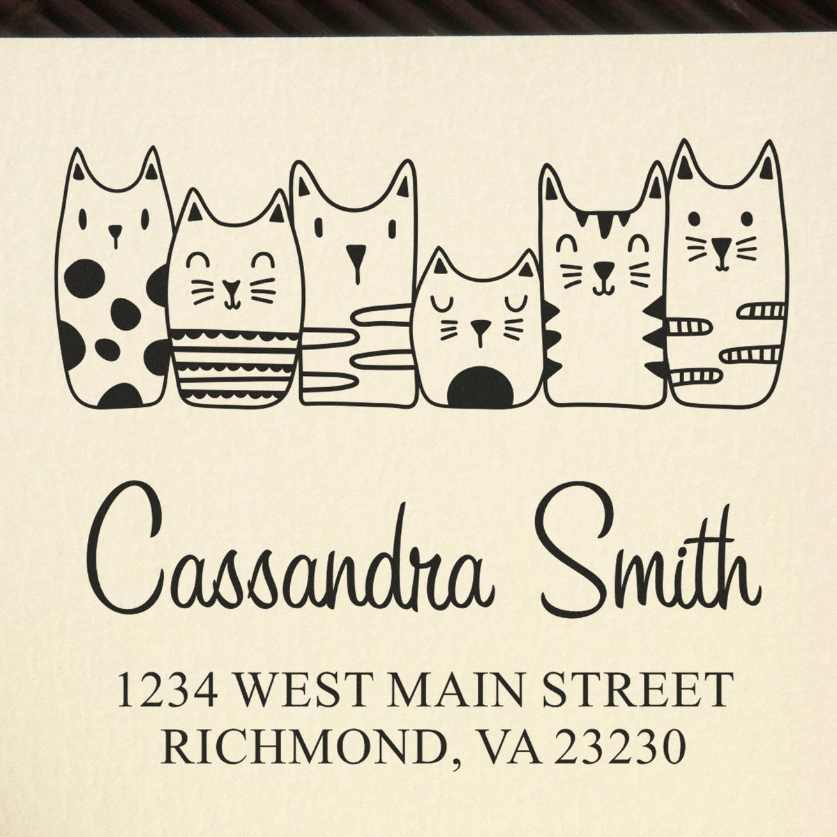 Personalized cat-themed address rubber stamp for Cassandra Smith, 1234 West Main Street, Richmond, VA 23230.