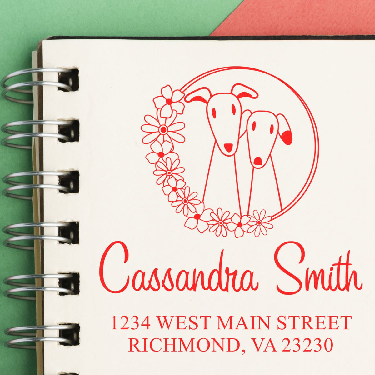 Custom rubber stamp with two dogs and floral wreath, personalized name and address for pet-themed stationery.