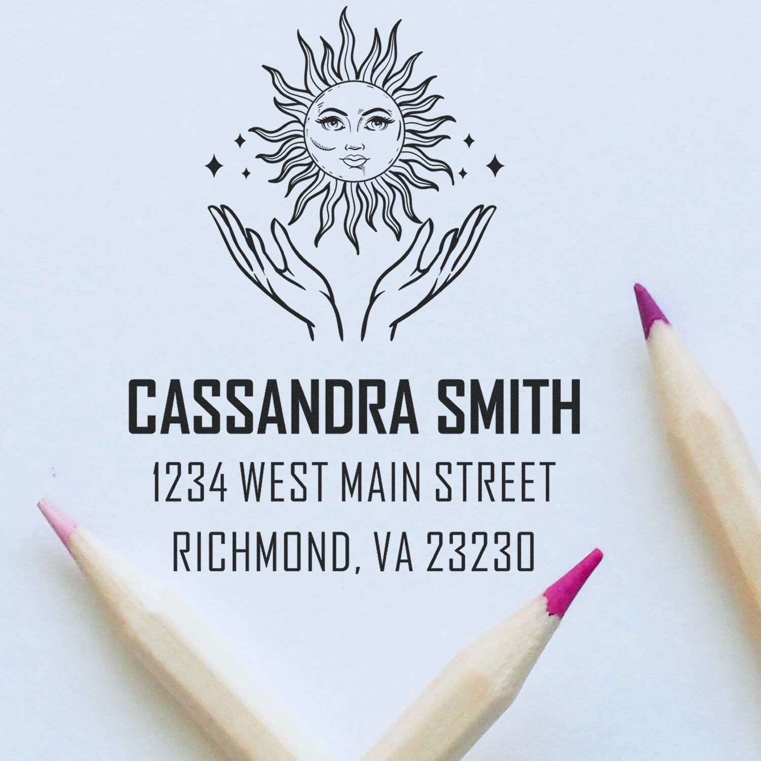 Custom rubber address stamp with sun and hands design, showing Cassandra Smiths Richmond, VA return address.