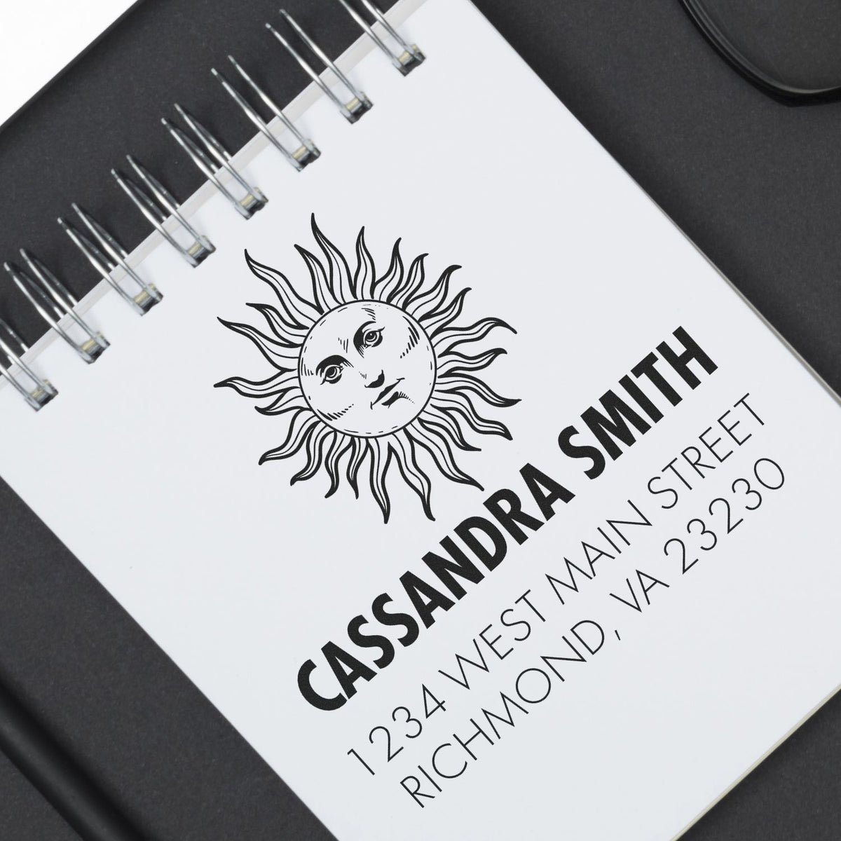 Custom return address rubber stamp with sun logo for Cassandra Smith, 1234 West Main Street, Richmond, VA 23230.