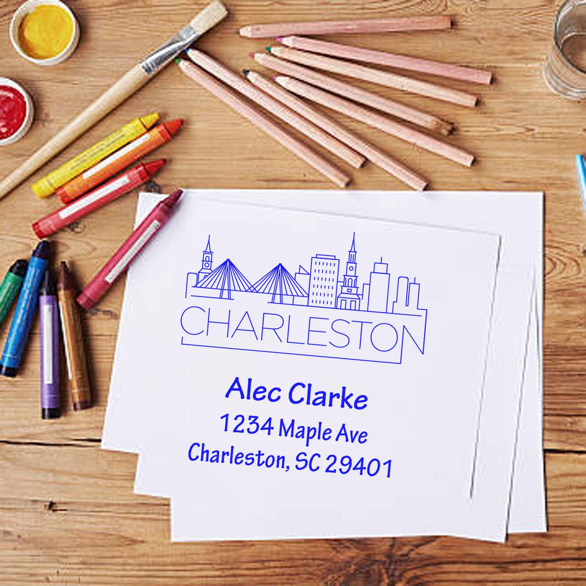 Custom Charleston return address stamp with skyline design, featuring name and address on stationery.