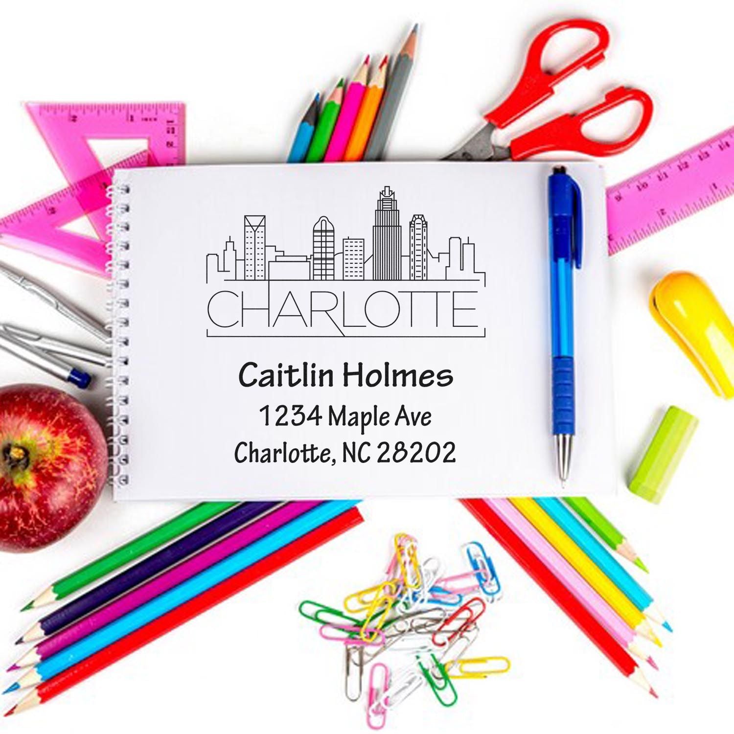 Personalized Charlotte return address rubber stamp with skyline, name and address, styled with colorful school supplies.