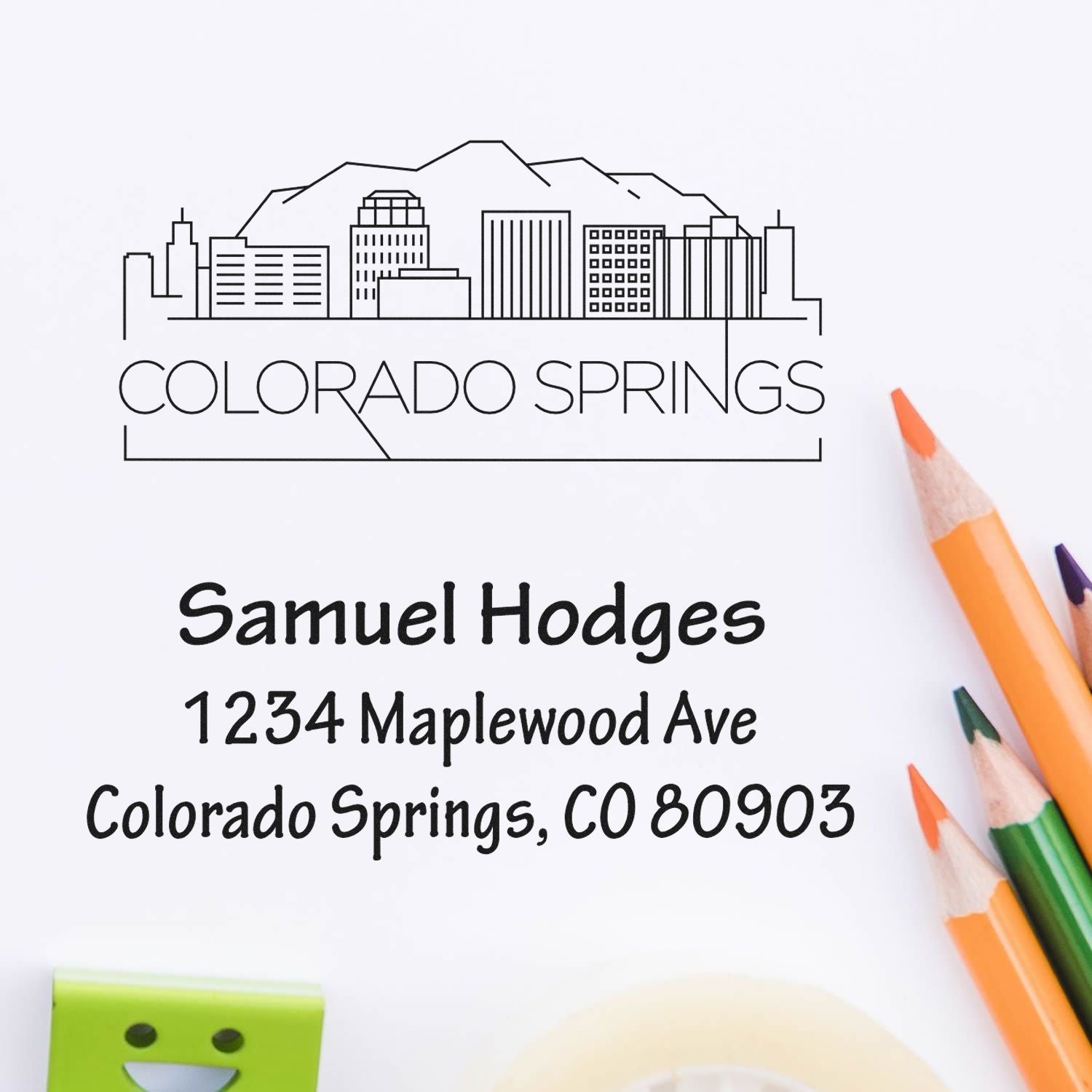 Custom return address rubber stamp featuring Colorado Springs skyline, name, street address, and ZIP code.
