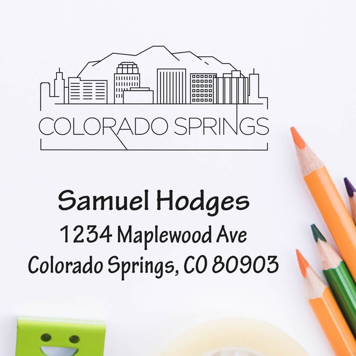 Custom Colorado Springs rubber stamp with skyline and return address: Samuel Hodges, 1234 Maplewood Ave, CO 80903
