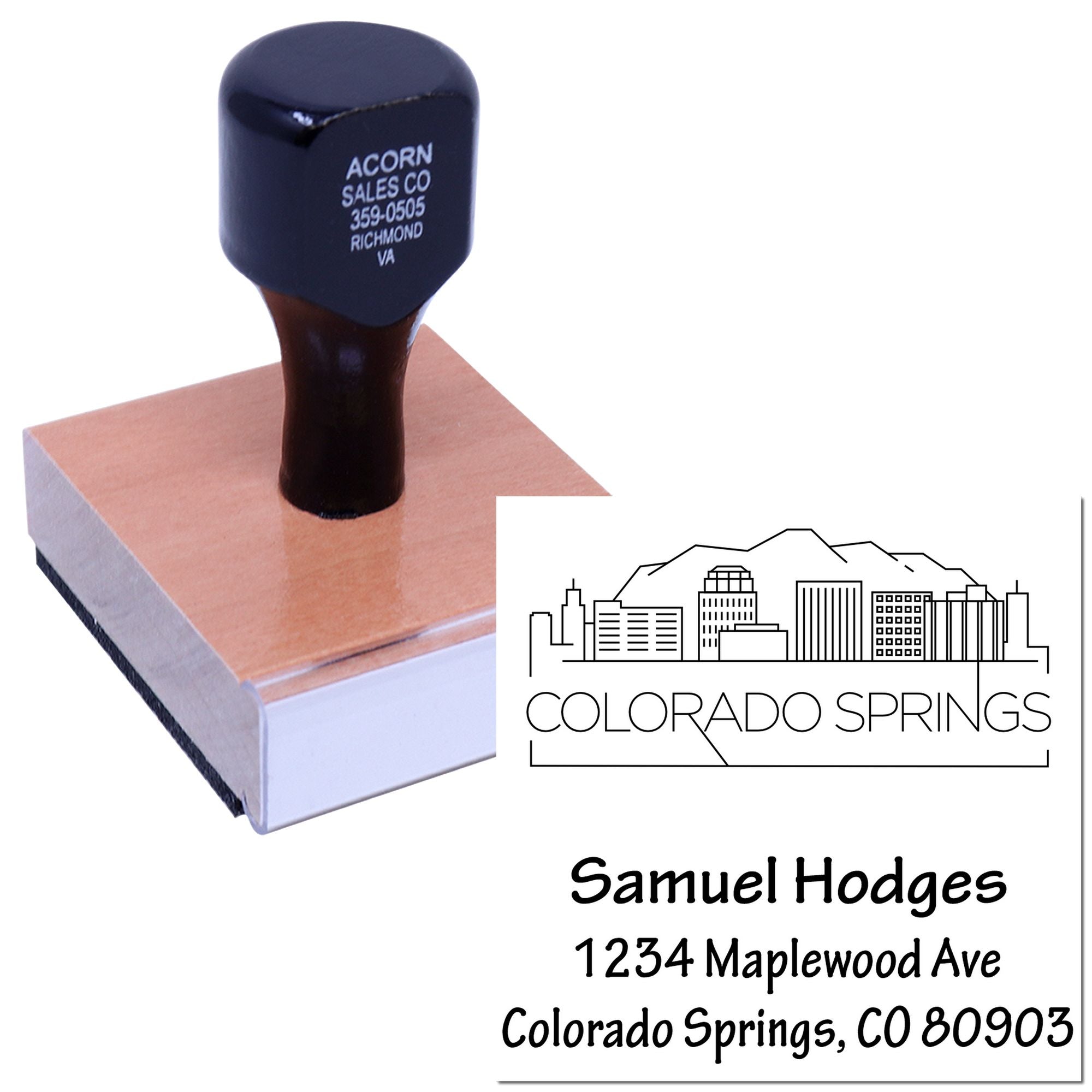 Custom return address rubber stamp with wood handle, showing Colorado Springs skyline and personalized name and address.