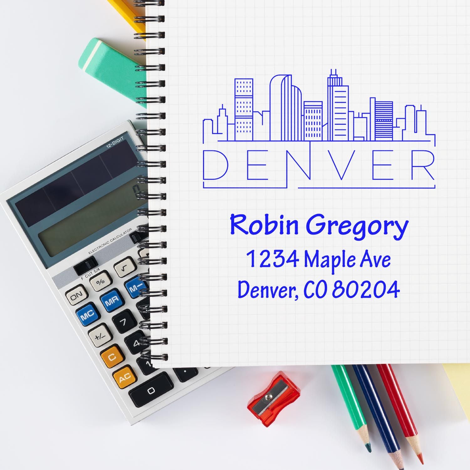 Custom Denver address rubber stamp with skyline logo, name, and return address for business mailings.