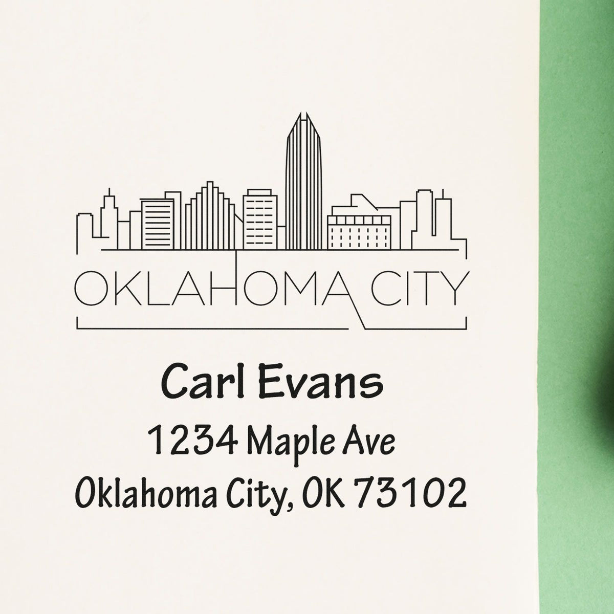 Custom Oklahoma City address rubber stamp with skyline design for Carl Evans, 1234 Maple Ave, OK 73102.