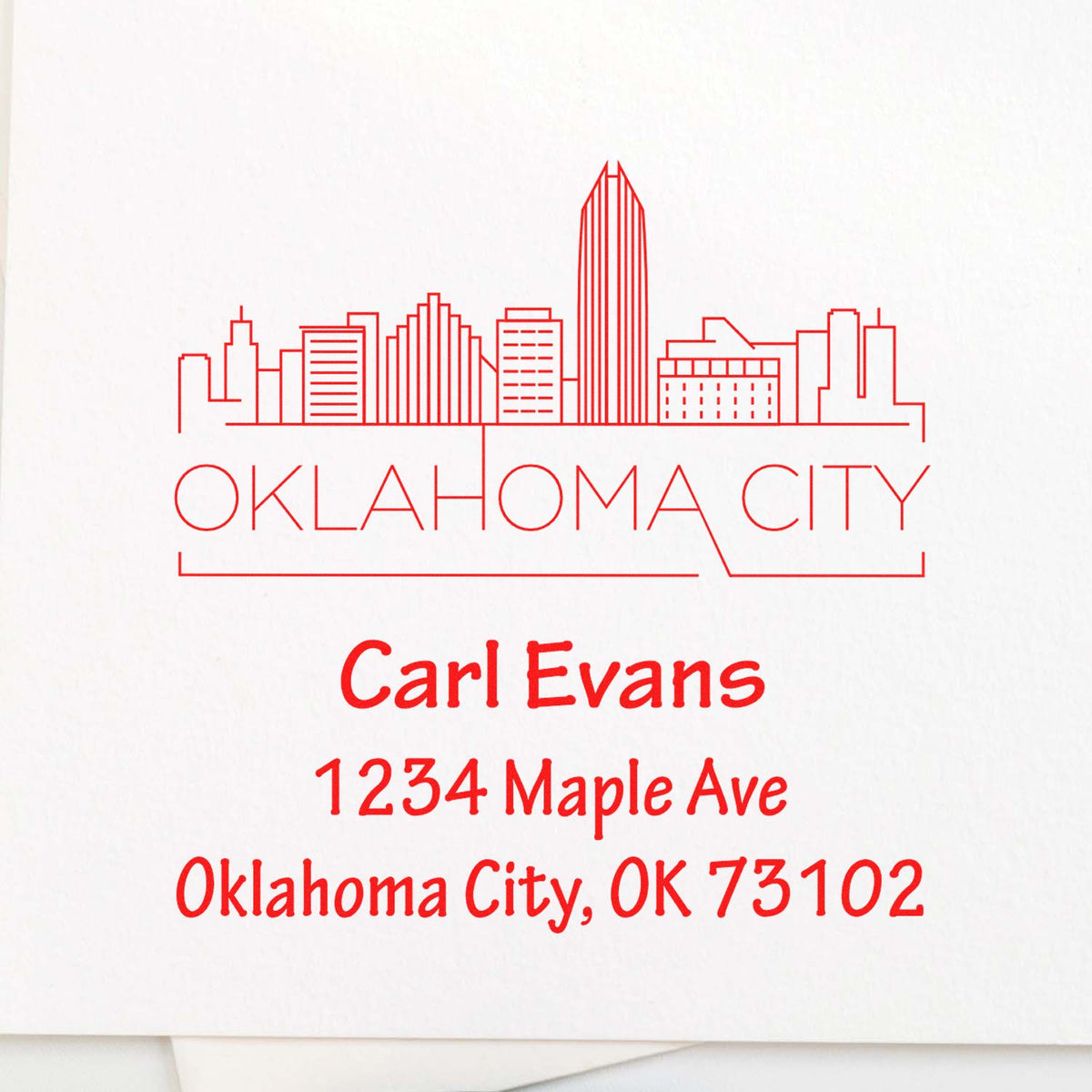 Custom Oklahoma City address rubber stamp with skyline graphic, Carl Evans, 1234 Maple Ave, Oklahoma City, OK 73102.