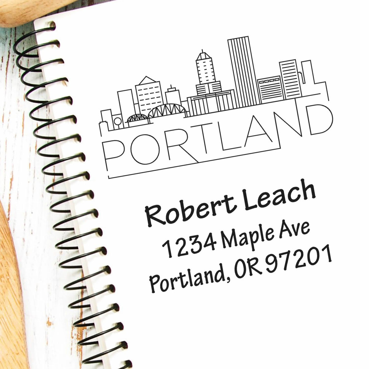 Custom Portland address rubber stamp with skyline design for envelopes, notebooks, and business branding.