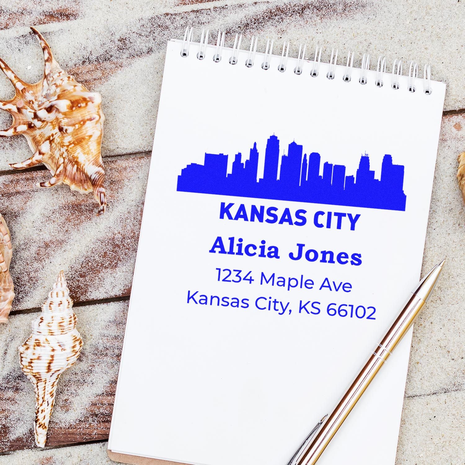 Kansas City return address rubber stamp with skyline and personalized name and address on a notebook.