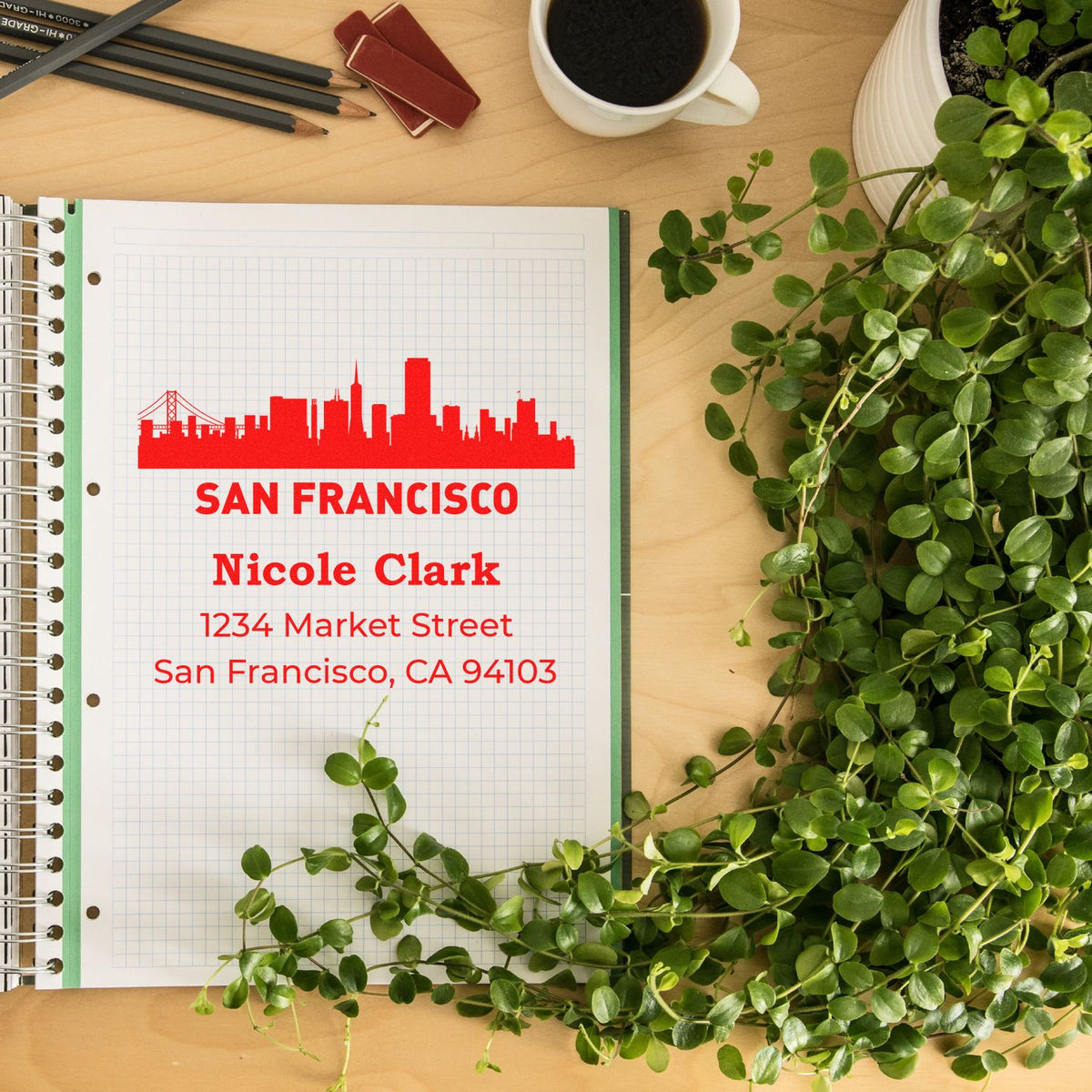 Personalized rubber stamp address imprint with San Francisco skyline and Nicole Clark address on planner paper.
