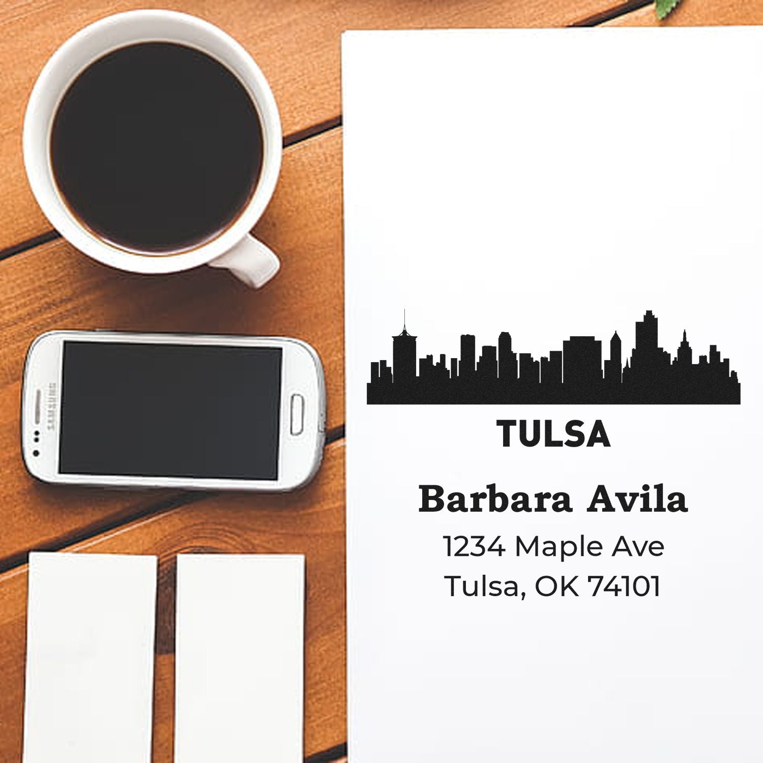 Custom Tulsa return address rubber stamp with skyline design for Barbara Avila, shown with mail stamp preview on paper.