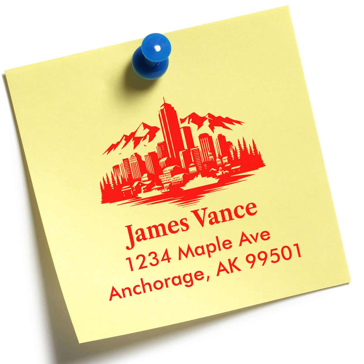 Personalized return address rubber stamp with city skyline design, showing James Vance and Anchorage, AK on a sticky note.