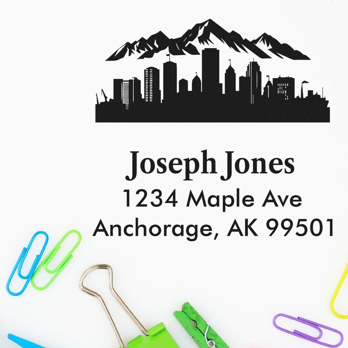 Custom return address rubber stamp with Anchorage skyline and mountain design, Joseph Jones, 1234 Maple Ave, Anchorage, AK 99501.