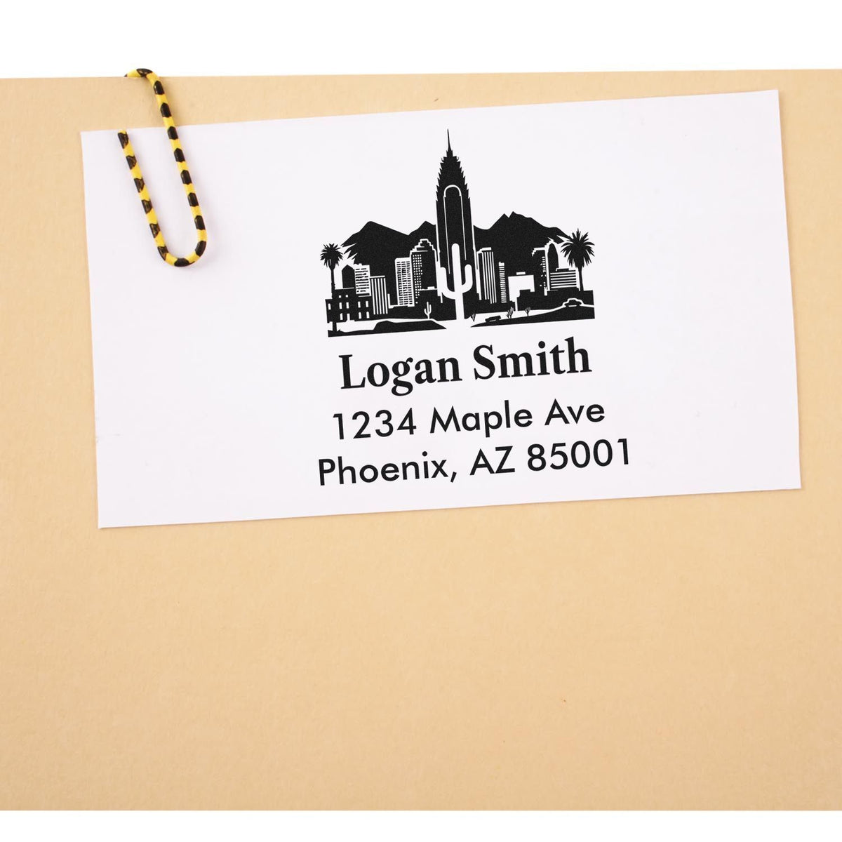 Custom return address rubber stamp with Phoenix skyline design, featuring Logan Smith, 1234 Maple Ave, Phoenix, AZ 85001