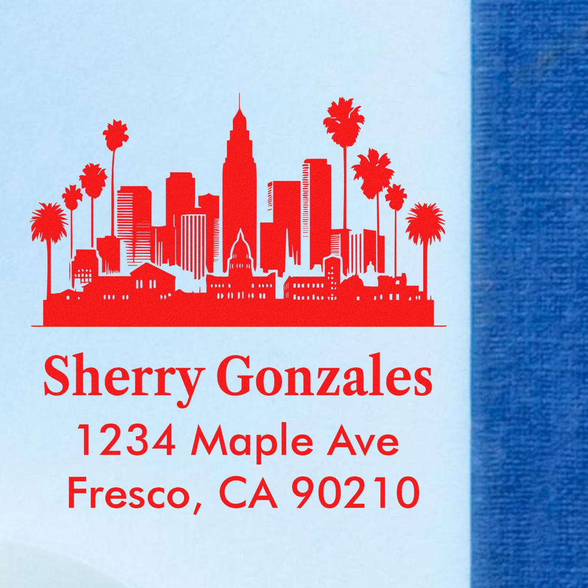 Custom return address rubber stamp with skyline and palm tree design for Sherry Gonzales, 1234 Maple Ave, Fresco, CA 90210.
