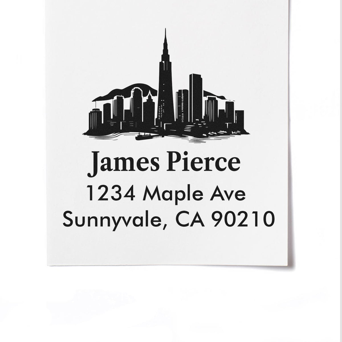 Custom return address rubber stamp with skyline design for James Pierce, 1234 Maple Ave, Sunnyvale, CA 90210.