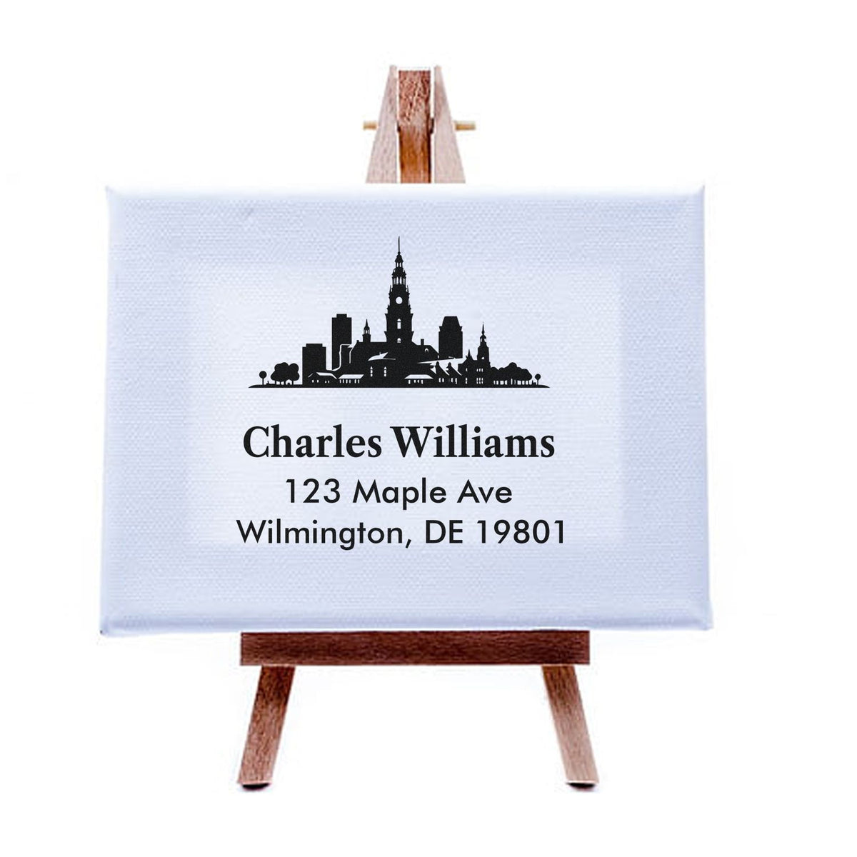 Custom return address rubber stamp with city skyline design for Charles Williams, 123 Maple Ave, Wilmington, DE 19801.