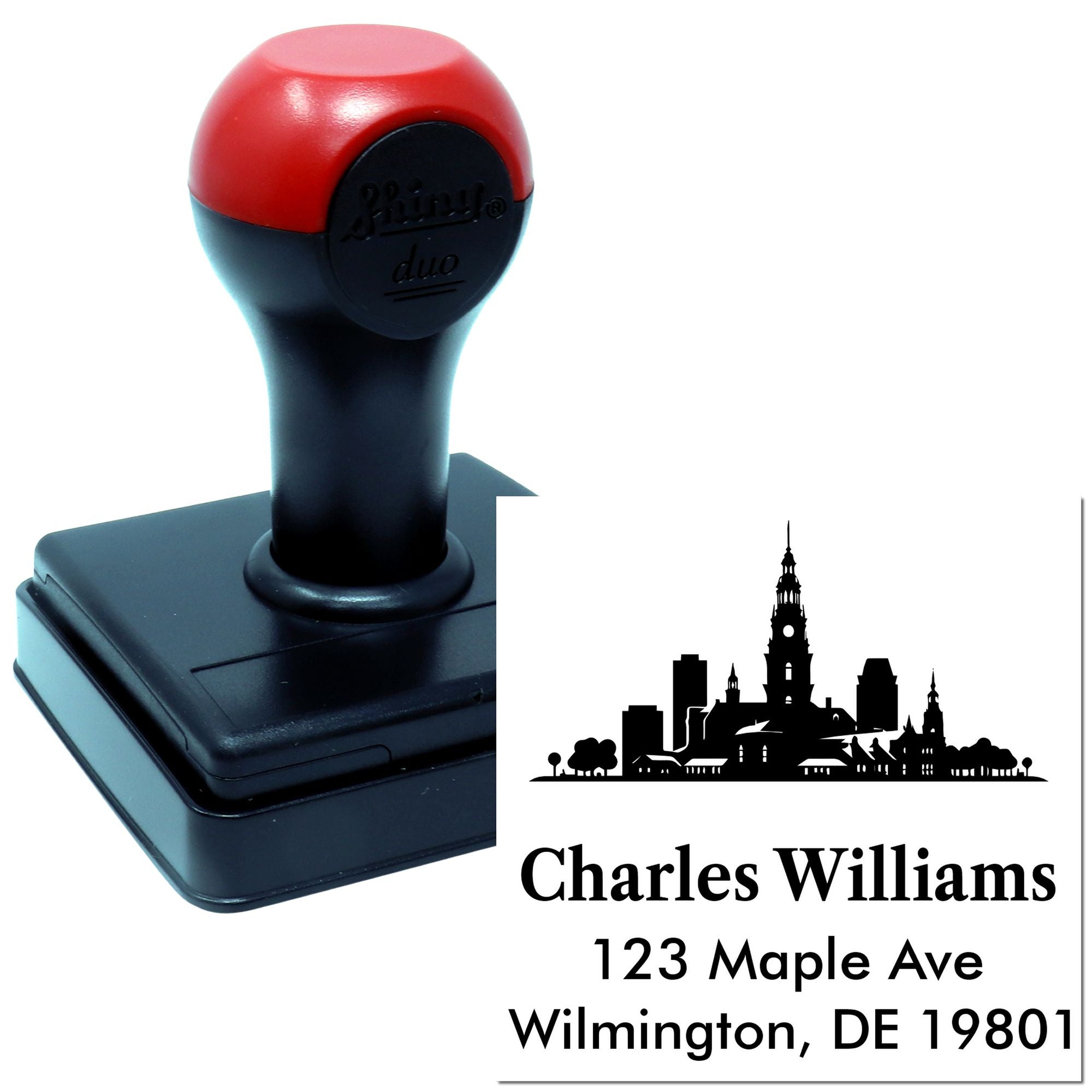Custom self-inking rubber address stamp with skyline design and personalized name and address imprint.