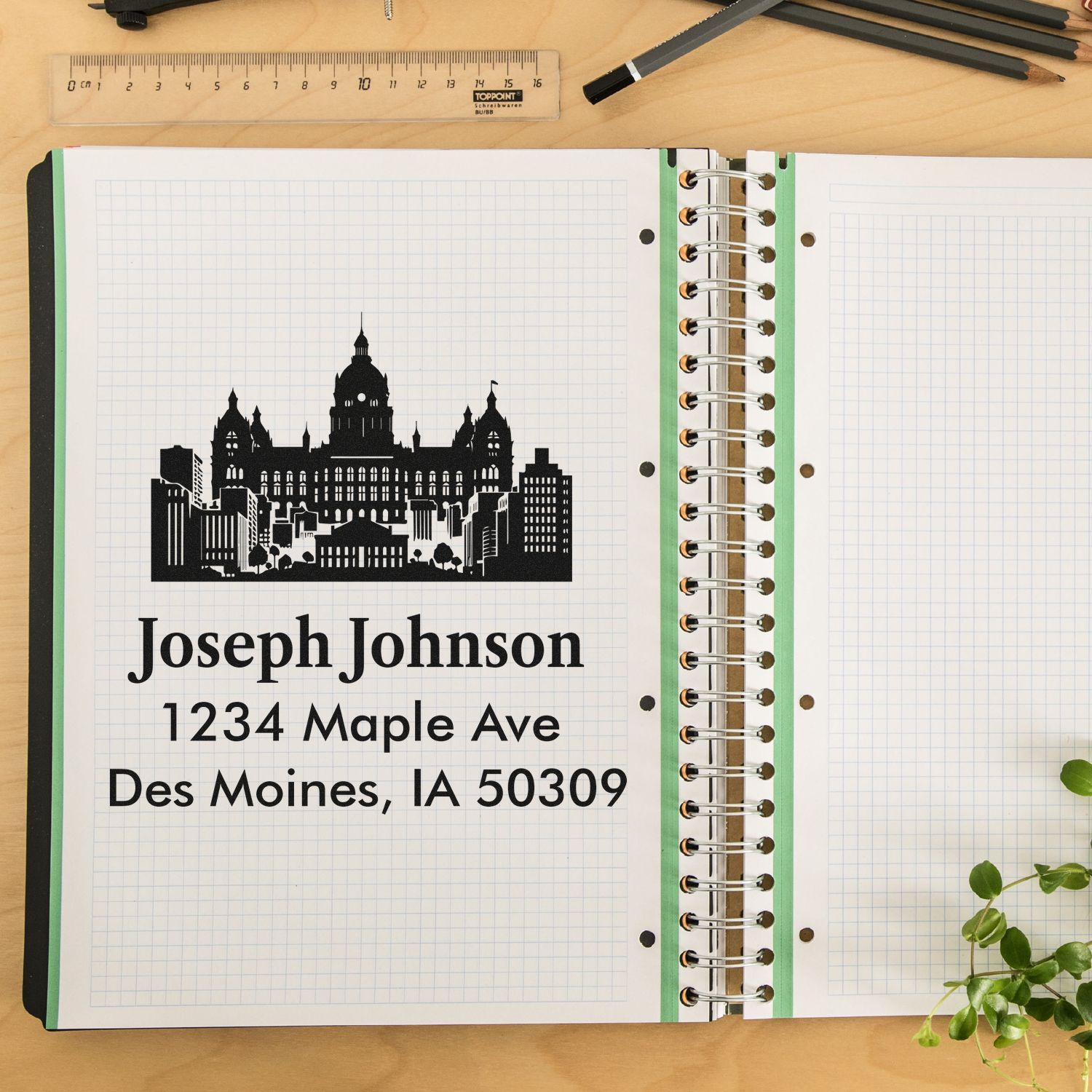 Personalized return address rubber stamp with skyline logo and Joseph Johnson address stamped on a planner page.