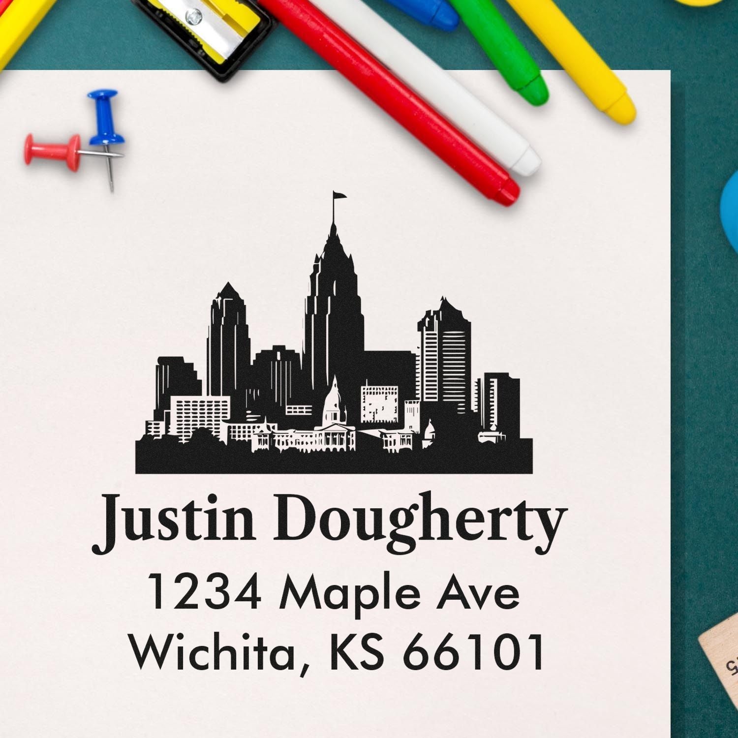 Custom return address stamp with Wichita skyline, Justin Dougherty, 1234 Maple Ave, Wichita, KS 66101.