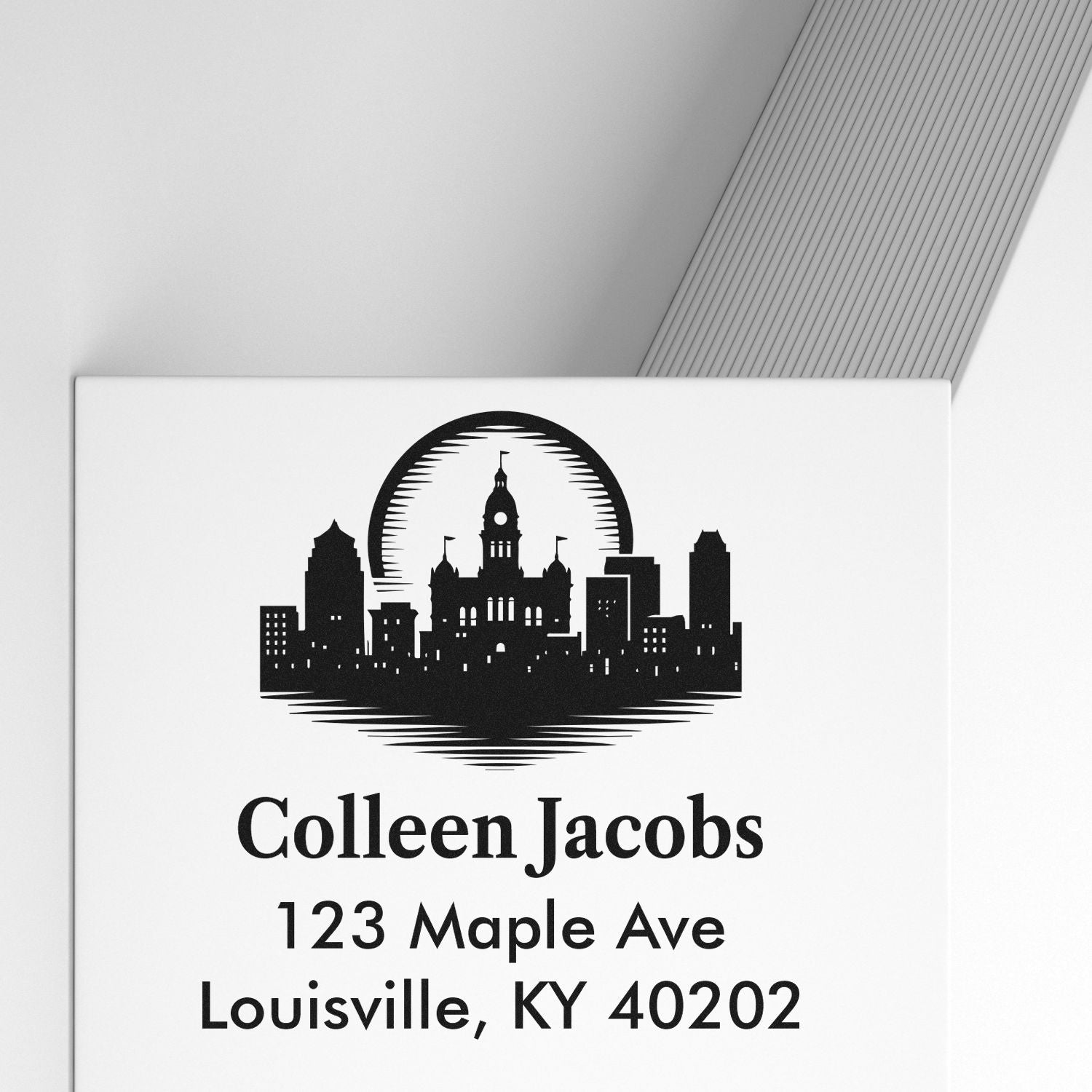 Custom return address rubber stamp with Louisville skyline logo for Colleen Jacobs, 123 Maple Ave, Louisville, KY 40202