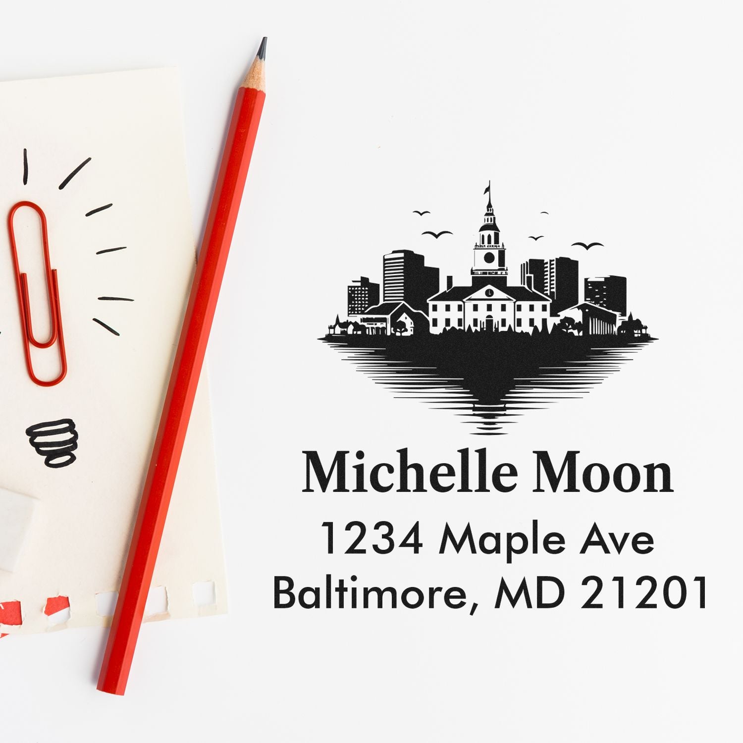 Custom rubber address stamp with Baltimore skyline design for Michelle Moon, 1234 Maple Ave, Baltimore, MD 21201.