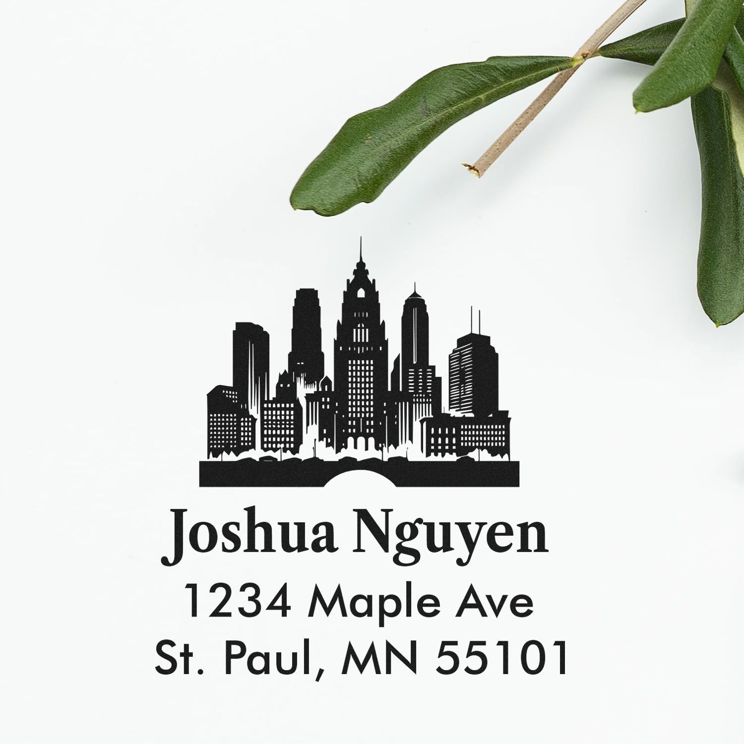 Custom return address rubber stamp with city skyline design, Joshua Nguyen, 1234 Maple Ave, St. Paul, MN 55101.