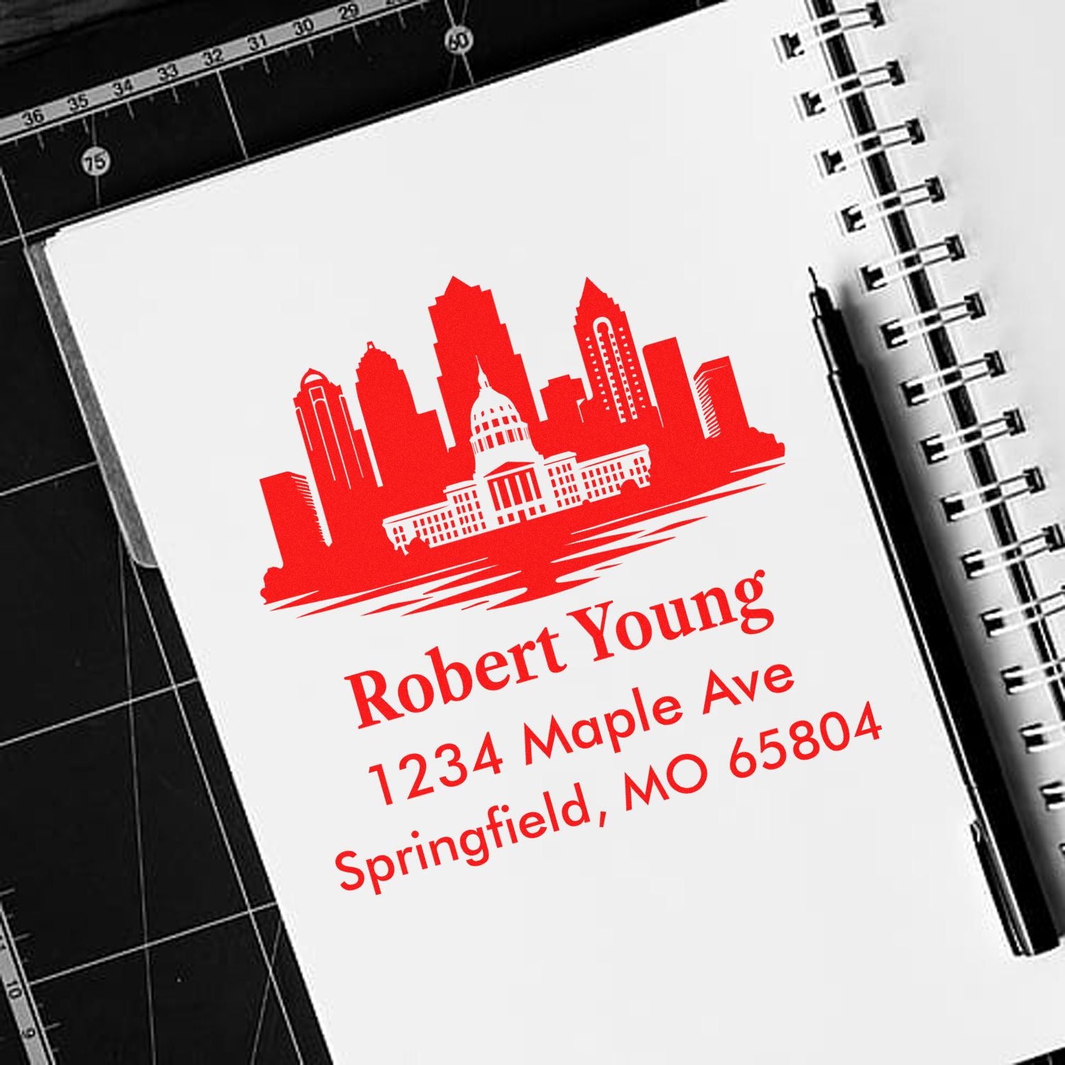 Custom return address rubber stamp with city skyline design, featuring Robert Young, 1234 Maple Ave, Springfield, MO 65804