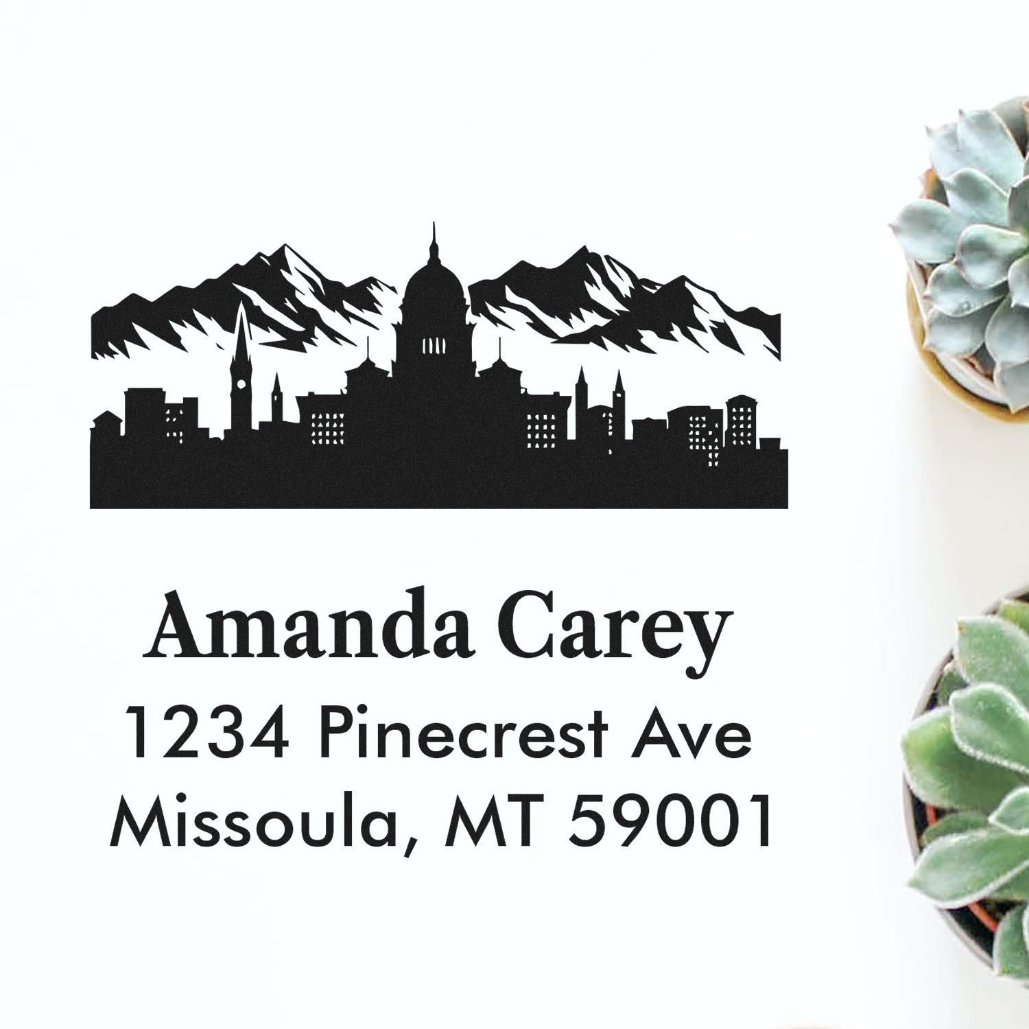 Personalized return address rubber stamp with mountain skyline, Amanda Carey, 1234 Pinecrest Ave, Missoula, MT 59001.
