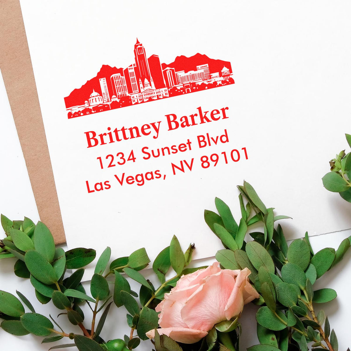 Custom red return address rubber stamp with Las Vegas skyline, Brittney Barker, 1234 Sunset Blvd, Las Vegas, NV 89101.