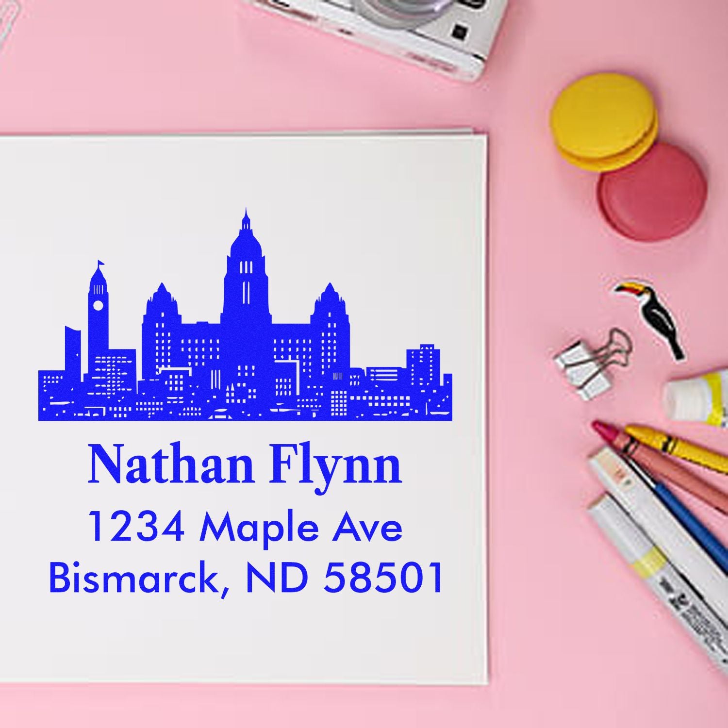 Personalized rubber address stamp with city skyline design, Nathan Flynn name, and Bismarck, ND return address.