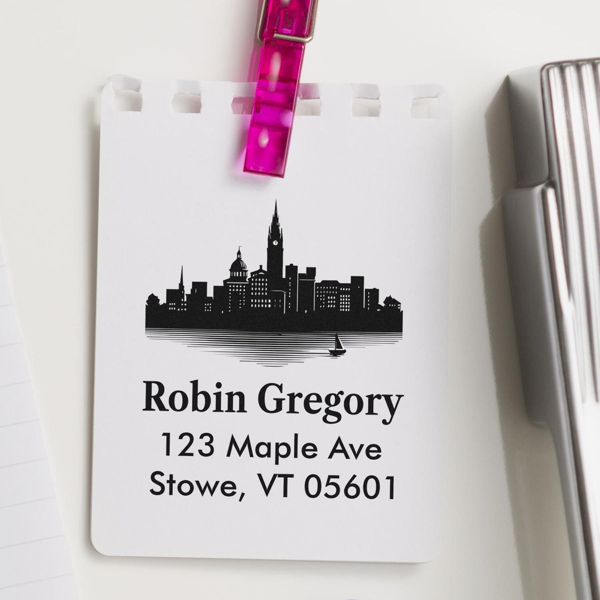 Custom address rubber stamp with skyline design for Robin Gregory, 123 Maple Ave, Stowe, VT 05601.