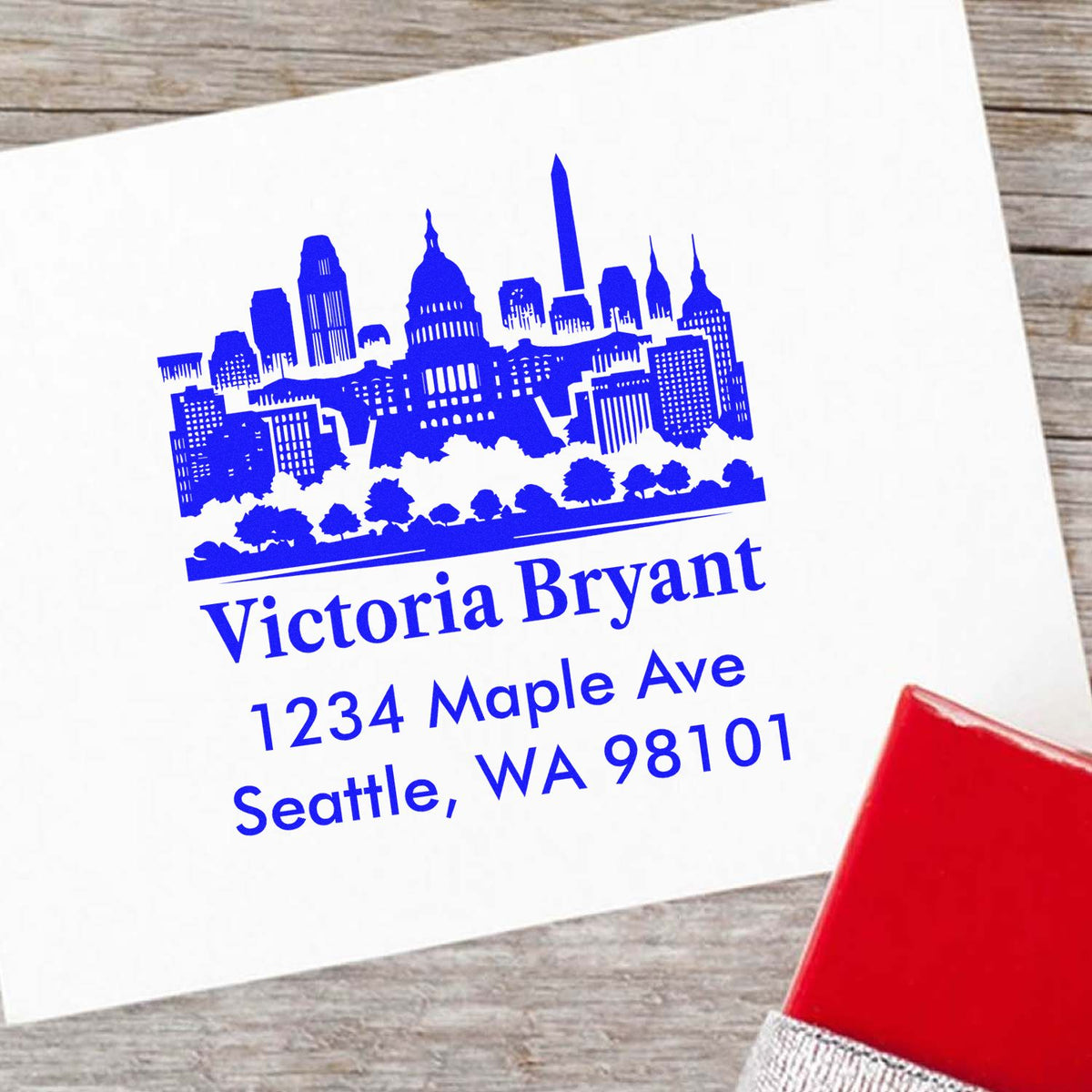 Custom return address rubber stamp with Seattle skyline, Victoria Bryant, 1234 Maple Ave, Seattle, WA 98101.