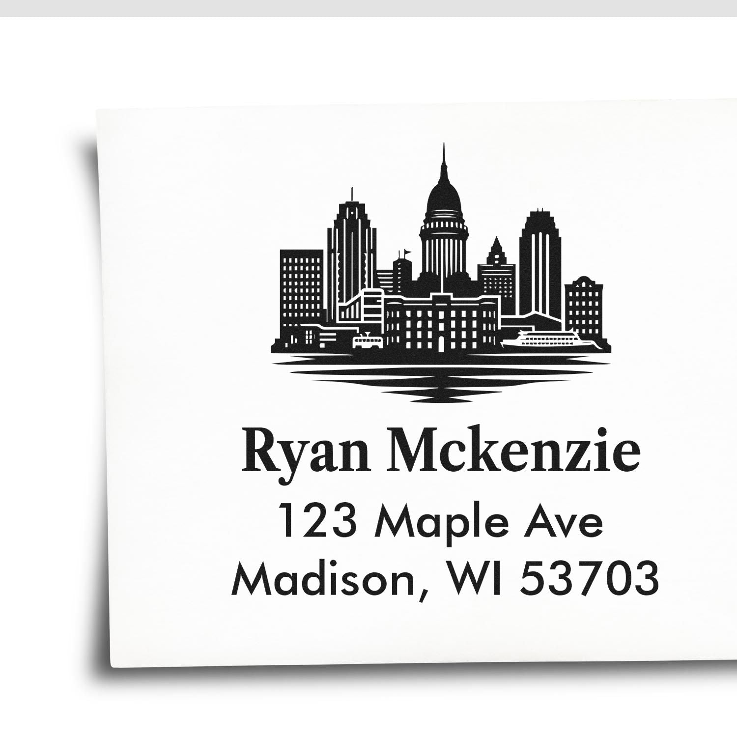 Custom rubber return address stamp with skyline design for Ryan Mckenzie, 123 Maple Ave, Madison, WI 53703.