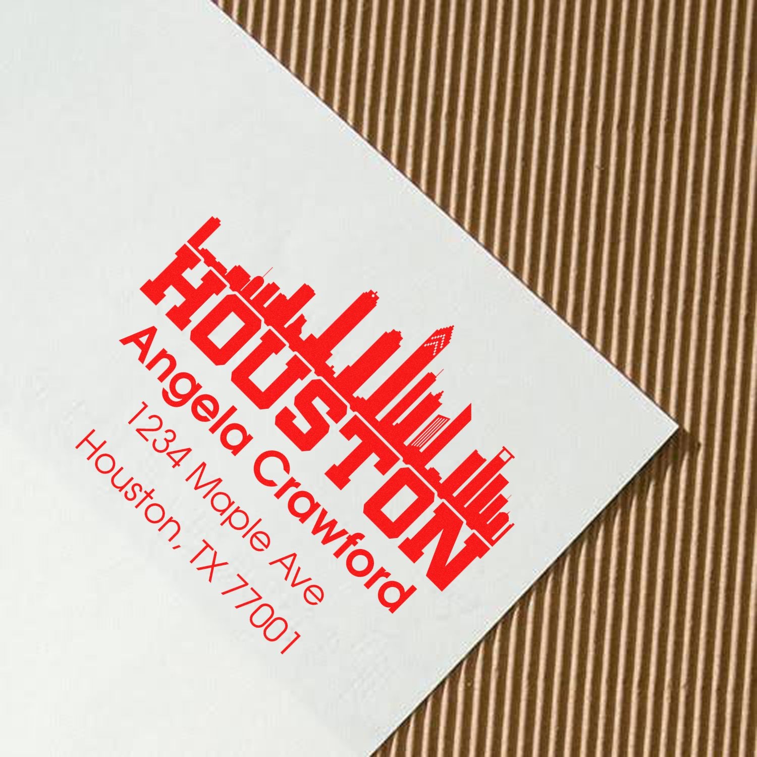 Custom Houston return address rubber stamp for Angela Crawford on white card.