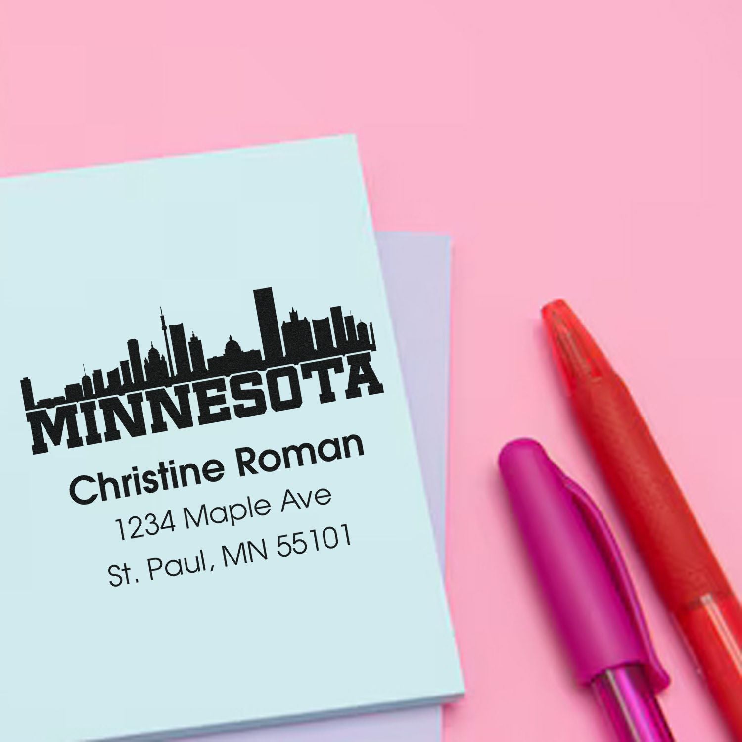 Custom Minnesota address rubber stamp with city skyline, personalized with Christine Roman, St. Paul, MN 55101.