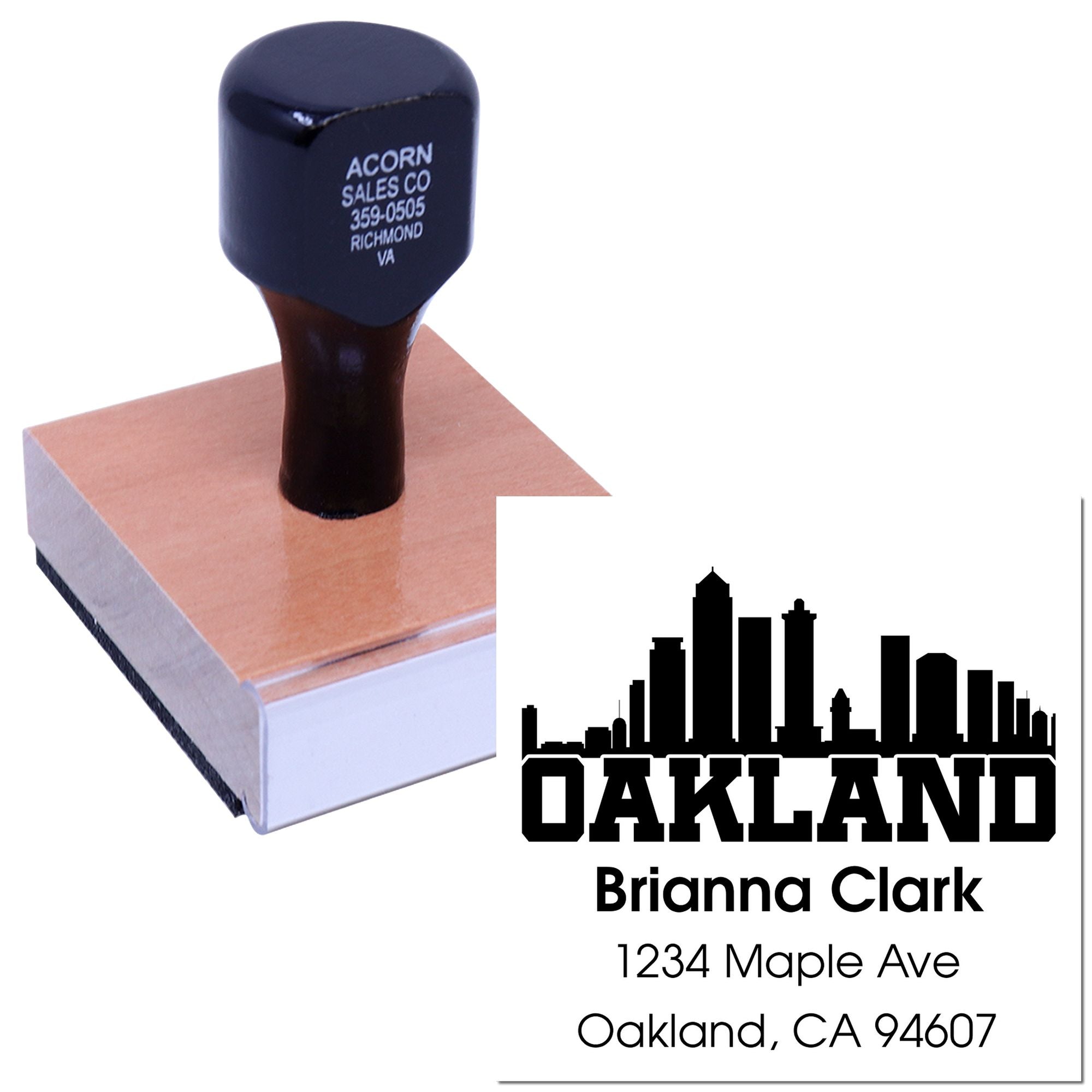 Personalized Oakland address rubber stamp with skyline for Brianna Clark, shown in use on a stamp block.