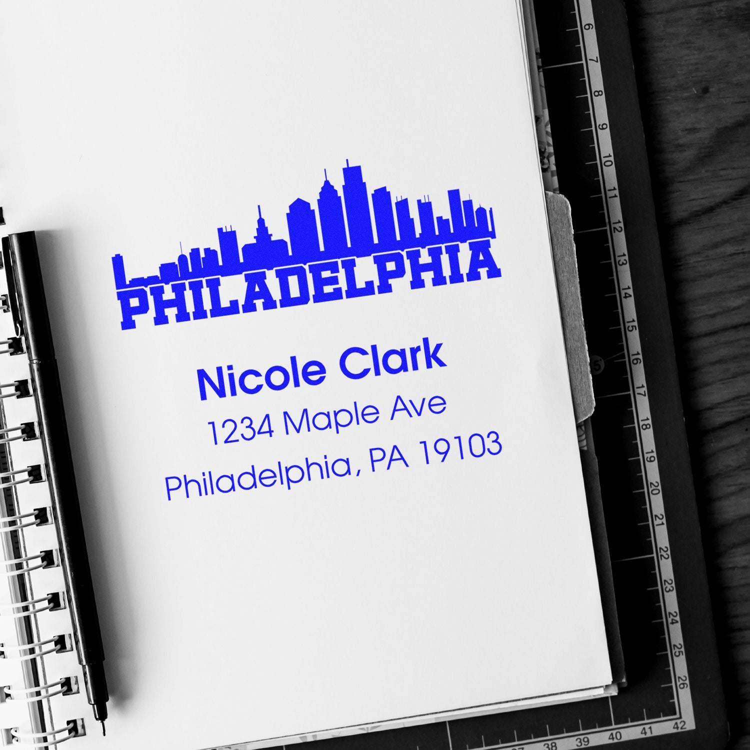 Custom rubber address stamp with Philadelphia skyline for Nicole Clark, 1234 Maple Ave, Philadelphia, PA 19103.