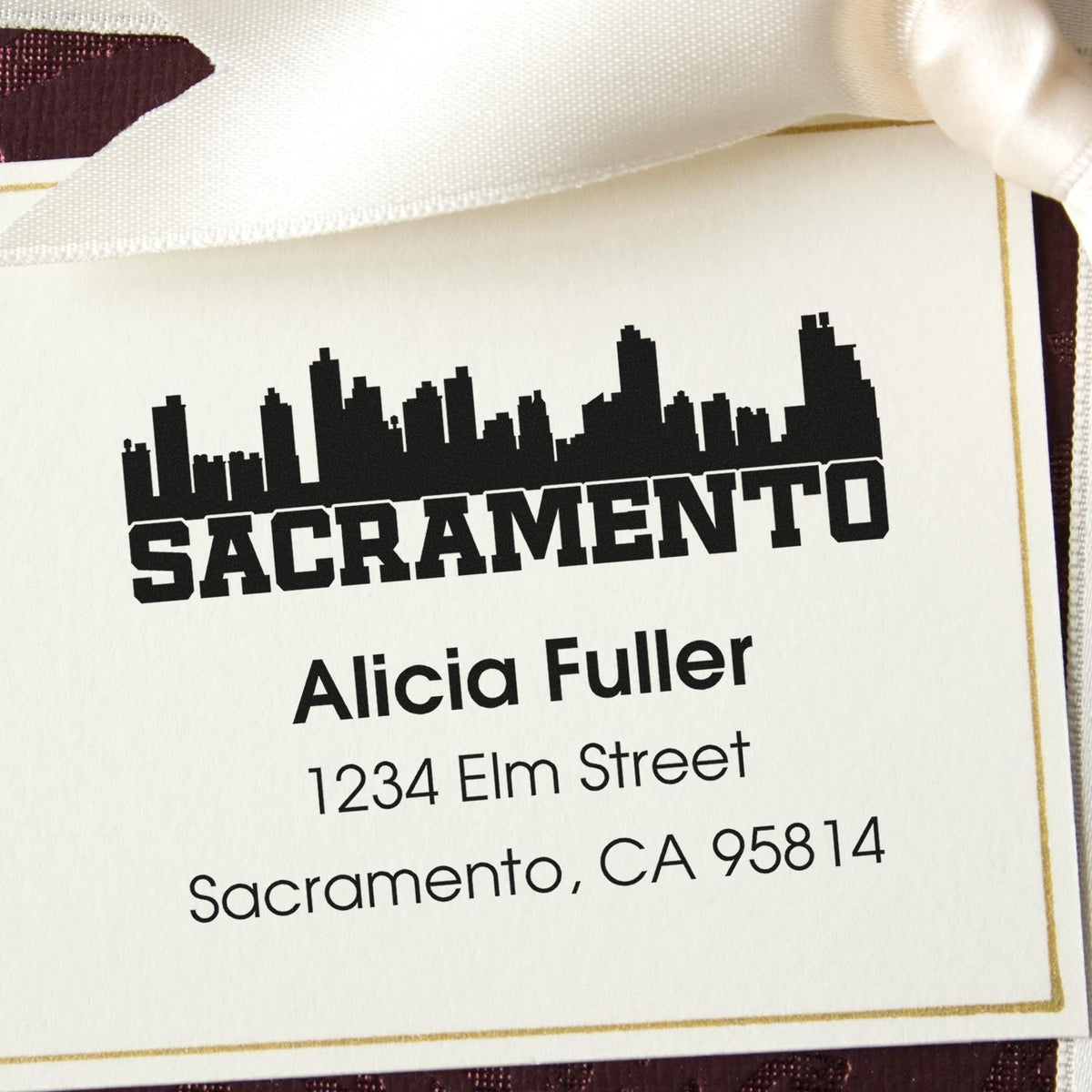 Custom Sacramento address rubber stamp with skyline design, featuring Alicia Fuller, 1234 Elm Street, Sacramento, CA 95814.