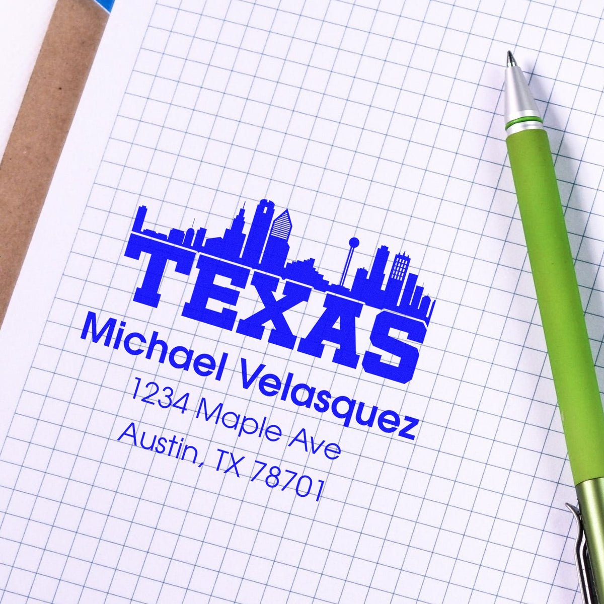 Personalized Texas return address rubber stamp with city skyline, name, and Austin, TX address on graph paper.