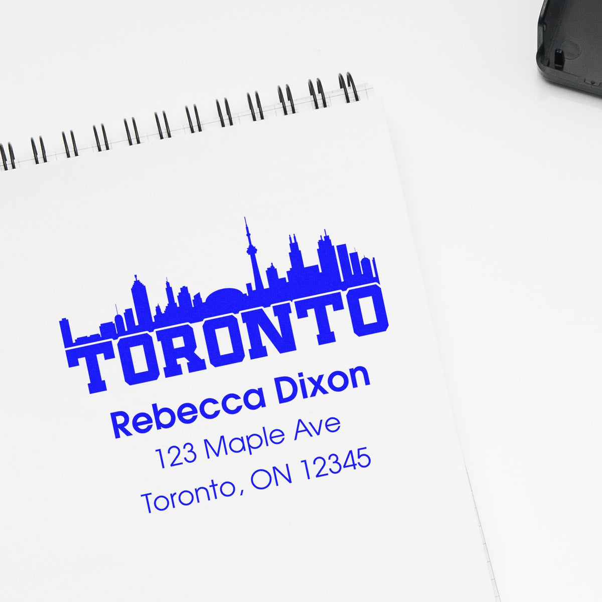 Custom Toronto rubber address stamp with skyline design, showing Rebecca Dixon name and mailing address.