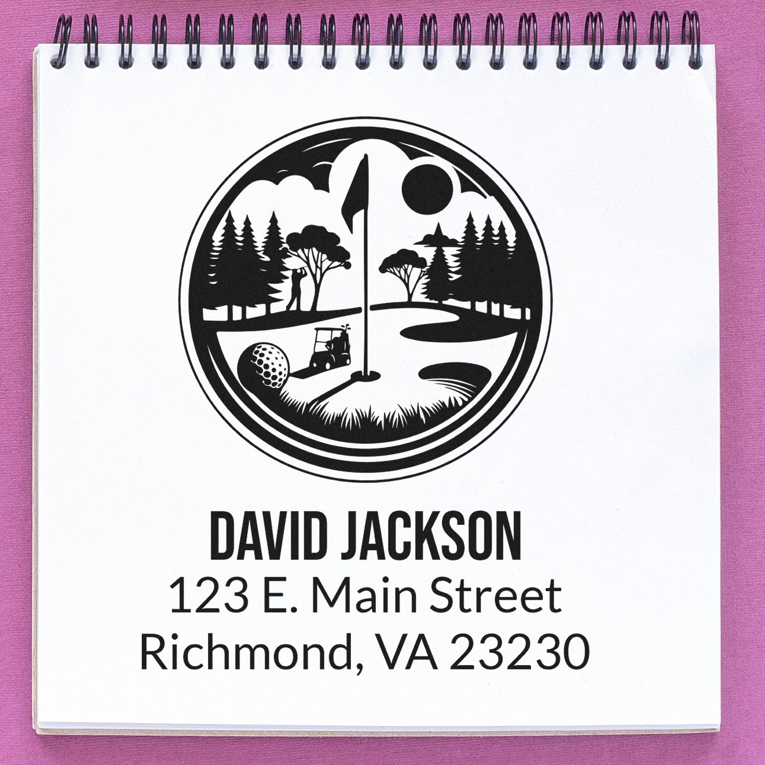 Custom golf address rubber stamp with logo, name, and Richmond, VA address on notebook paper.