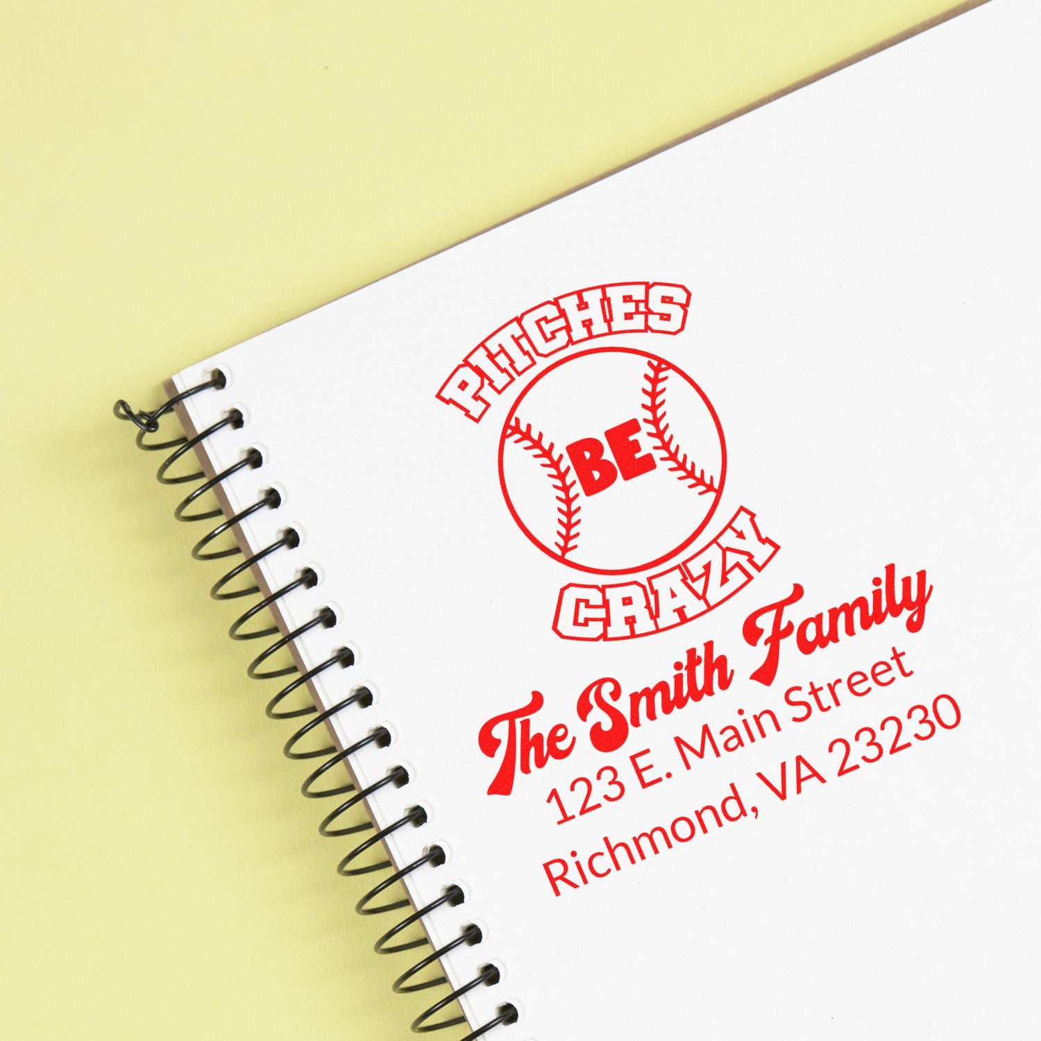 Personalized baseball rubber stamp with Phitches Be Crazy design and Smith family address on a spiral notebook.