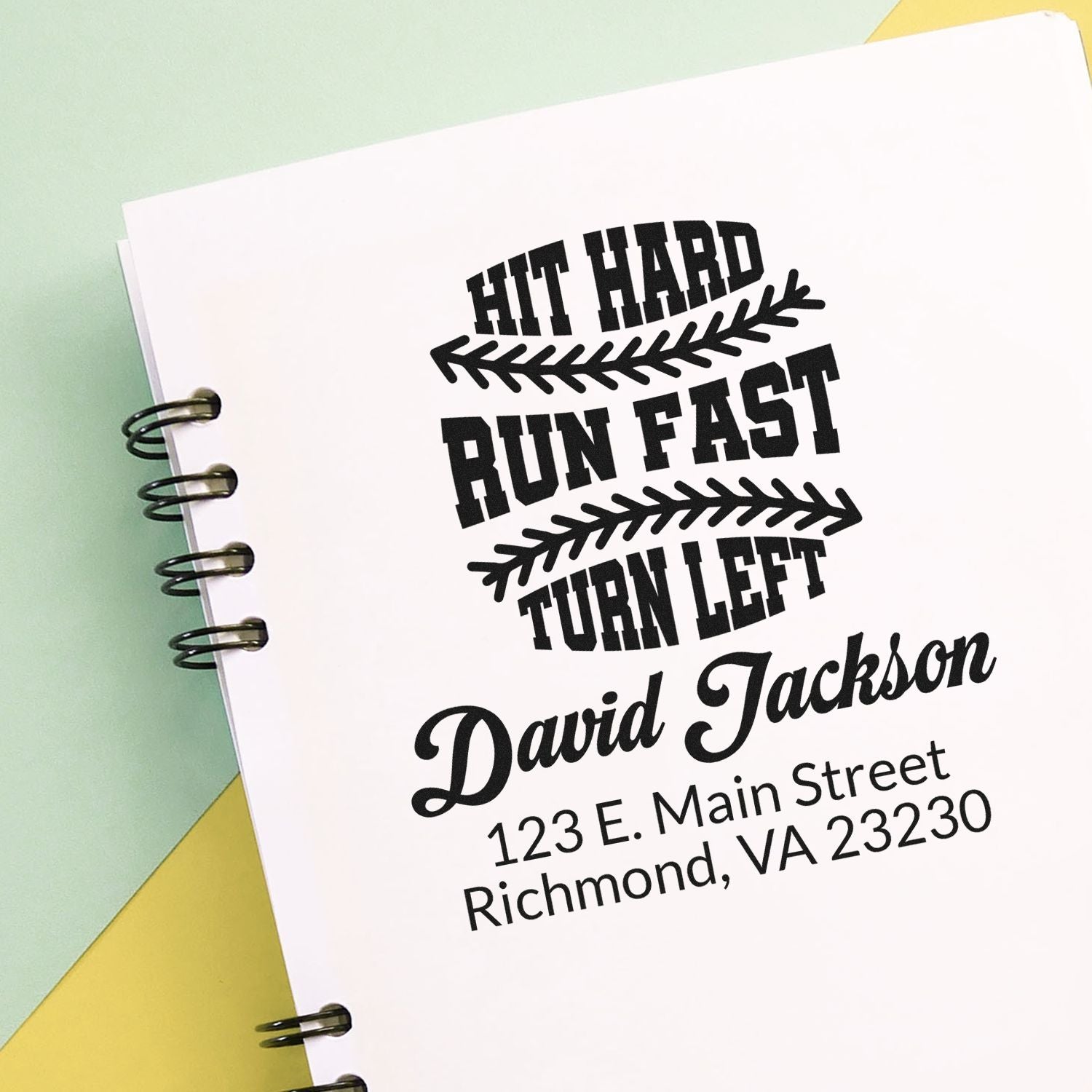 Custom rubber stamp impression with baseball slogan, name, and address for personalized stationery and branding.