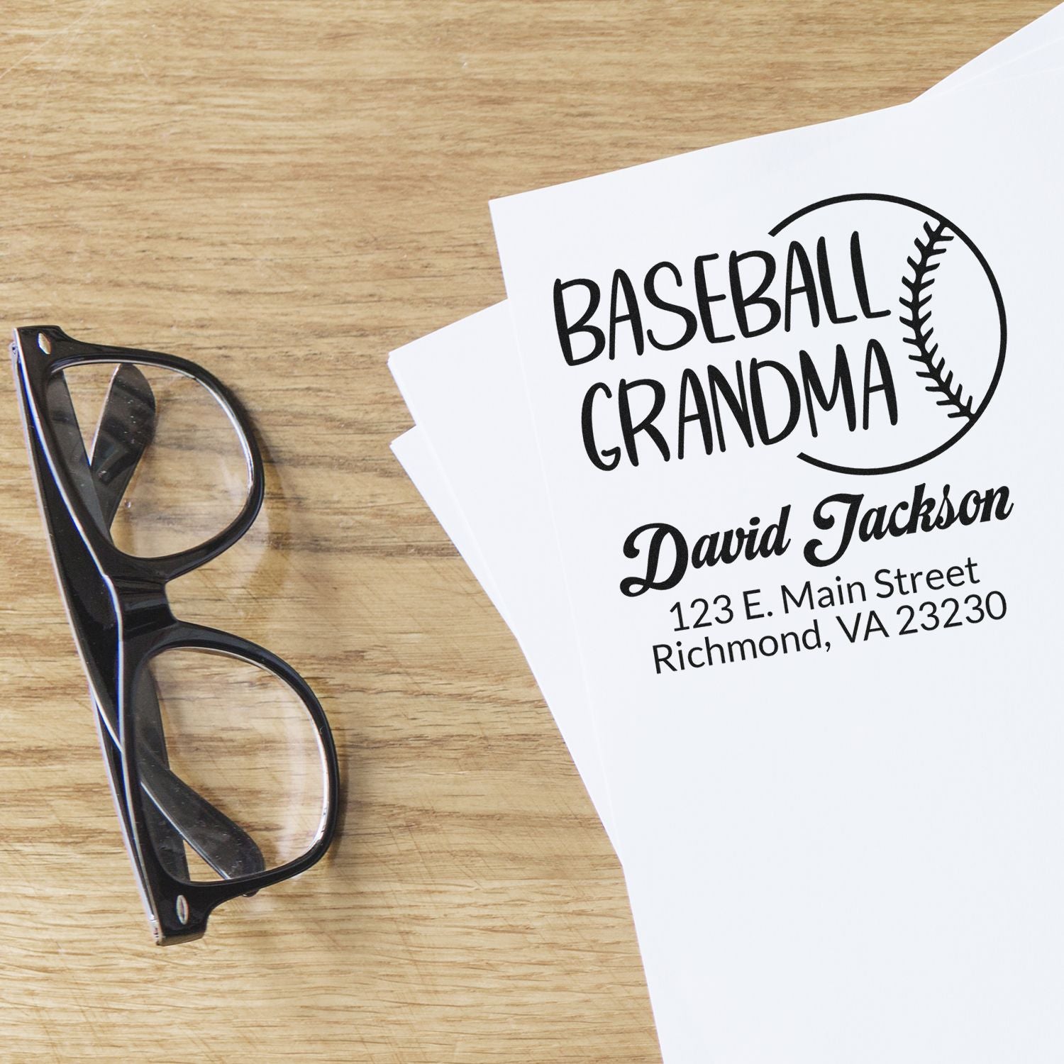 Custom baseball grandma rubber stamp with personalized name and address, shown on a paper sample.