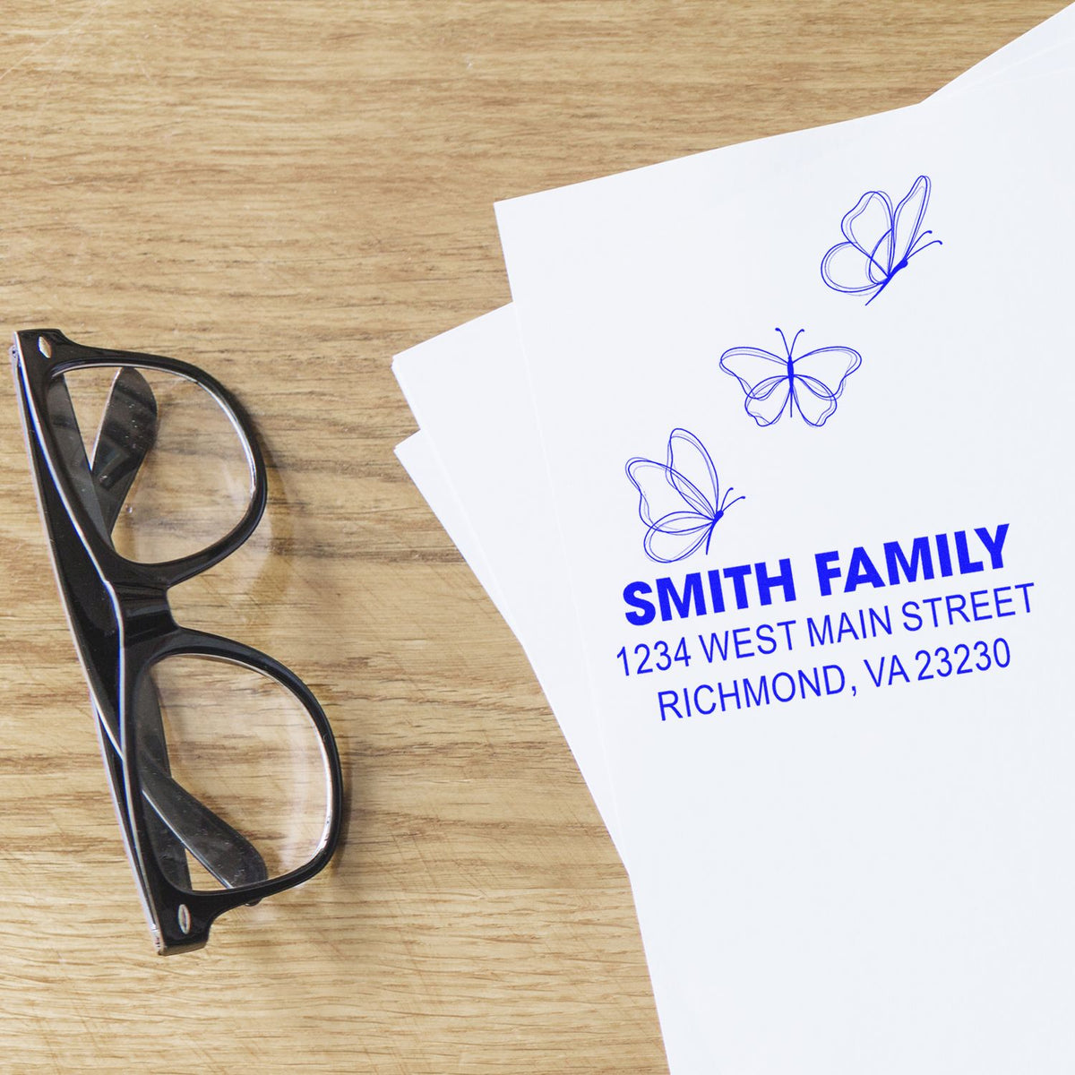 Custom butterfly return address rubber stamp with Smith Family name and Richmond, VA address on paper.