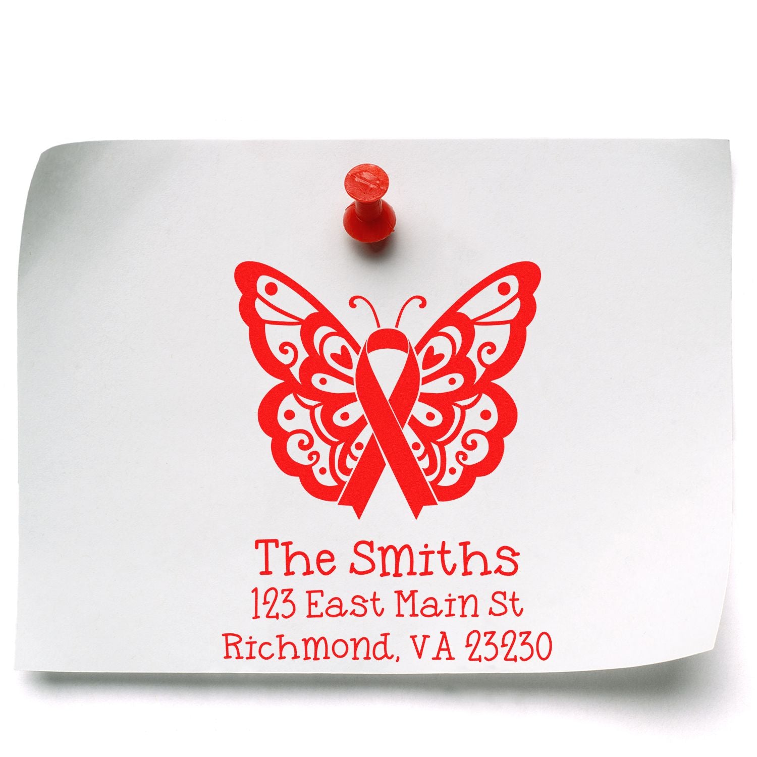 Custom rubber address stamp with butterfly and ribbon design for The Smiths on a white envelope.