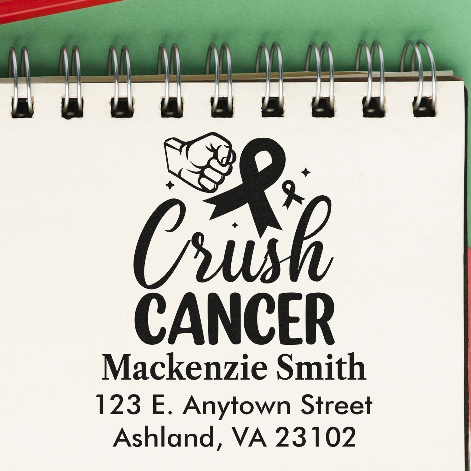 Custom rubber stamp design for Crush Cancer awareness, featuring a ribbon, fist icon, name, and address.